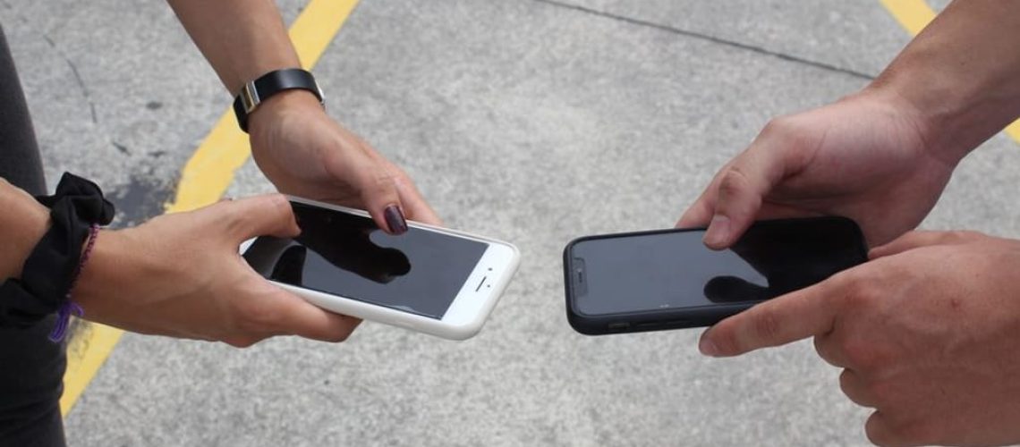 comparing two smartphones hands